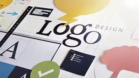 Paper cutouts and pages on a table with the word, logo displayed